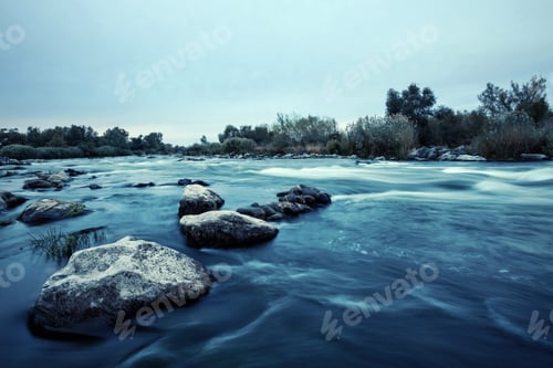Preview: Stones in the water on shallow mountain river.