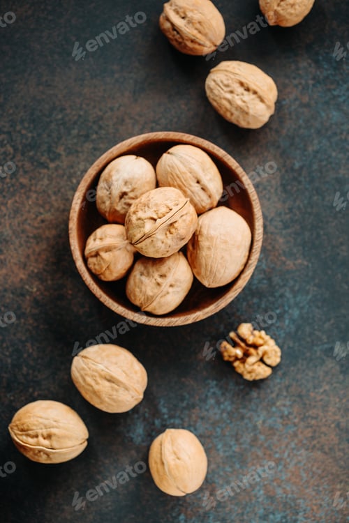 Preview: Top view on a heap of walnuts on a table.