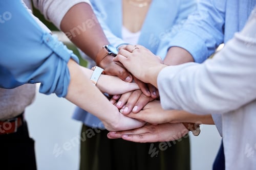 Preview: Helping each other achieve greatness. Shot of a group of business people with their hands stacked.