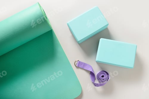 Preview: Green mat, yoga blocks and belt. Yoga practice, stretching concept.
