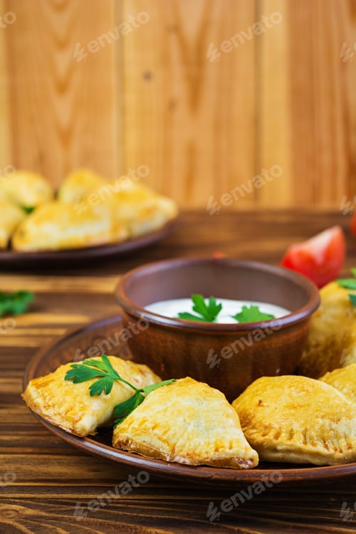 Preview: Delicious baked empanadas on wooden background