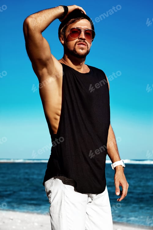 Preview: Portrait of handsome man posing at the beach