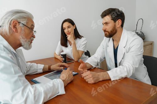 Preview: Successful medical doctors are discussing diagnosis during the conference