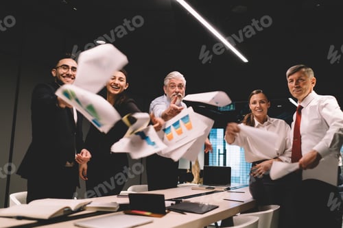 Preview: Group of diverse colleagues standing with documents in office meeting room