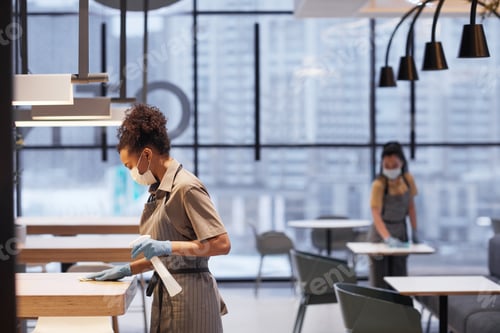 Preview: Workers Sanitizing Tables in Restaurant