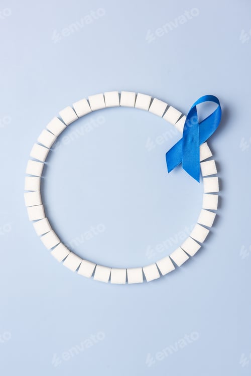 Preview: World Diabetes Day, sugar cubes ring and blue ribbon, copy space background