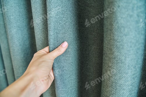 Preview: Woman's hand touching curtain, green fabric with burlap texture, blackout fabric