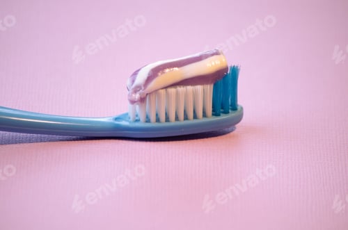 Preview: toothbrush with toothpaste on pink background,