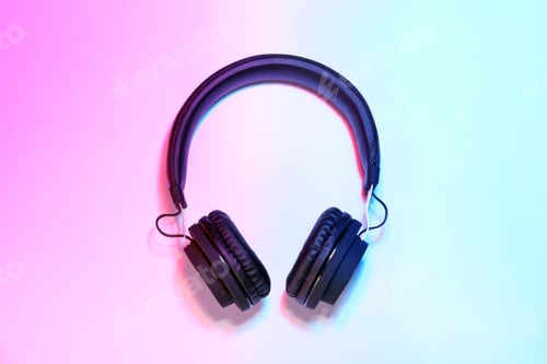 Preview: Stylish headphones on color background, top view