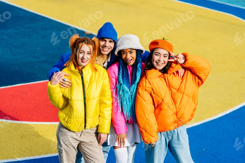 Preview: Multiracial group of young friends meeting outdoors in winter