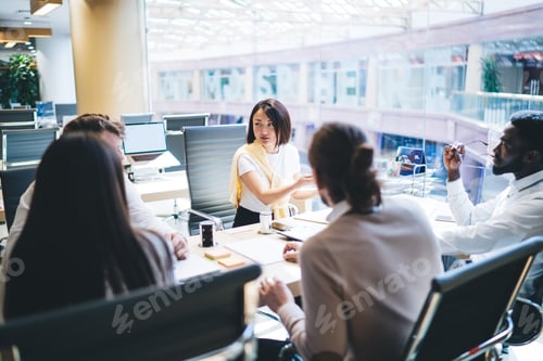 Preview: Multiracial professionals discussing marketing plan during corporate cooperation at office desktop