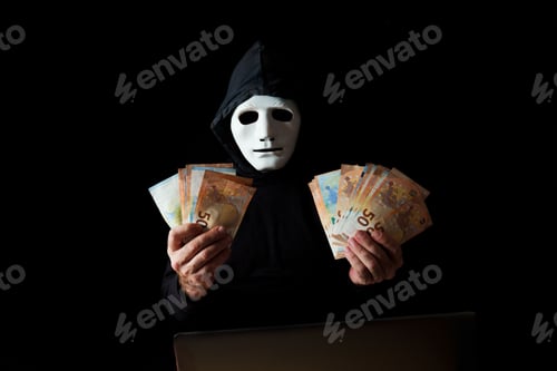 Preview: hacker man dressed in black with white mask and black hood holding euro banknotes in his hands
