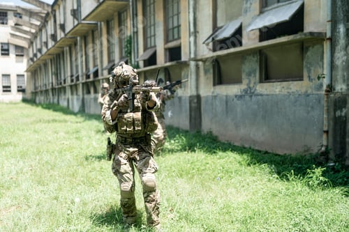 Preview: Soldier in full US MARSOC armed with assault rifle run through the abandoned building. Military