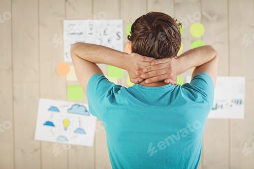 Preview: Casual worker looking at brainstorm wall in his office