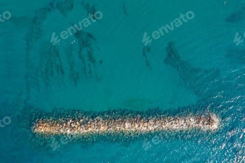Preview: Aerial view from a flying drone of blue sea water and breakwater