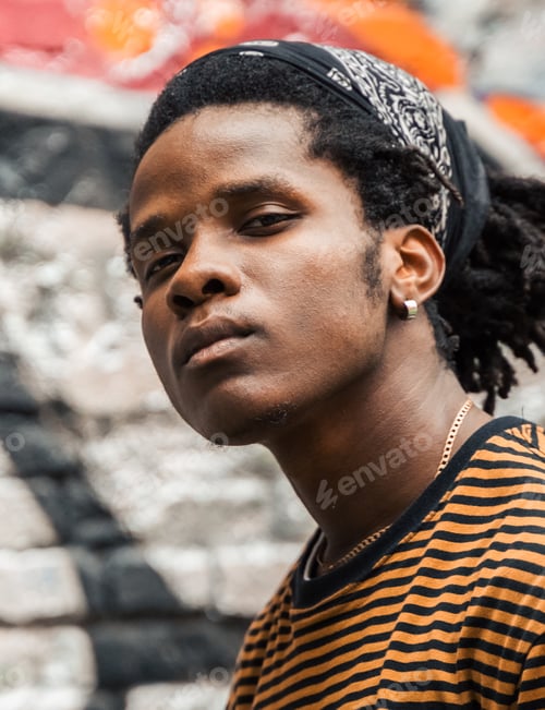 Preview: Portrait of young handsome stylish black man with natural hair afro dreadlocks. Afroamerican guy. St