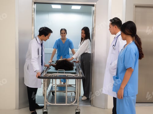 Preview: At hospital doctor and nurse looking at medical team in elevator transfer patient to treatment room