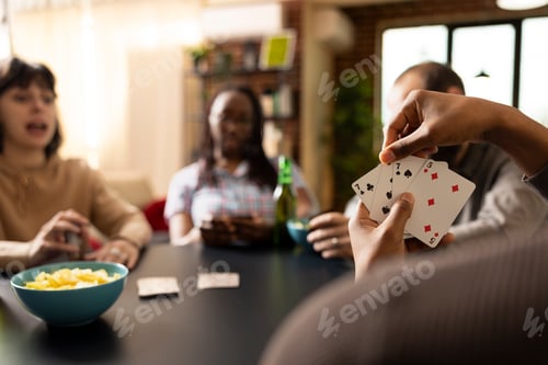 Preview: Playing cards at friendly group hangout