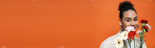 Preview: cheerful attractive model in stylish attire with vivid makeup posing with flower bouquet, banner