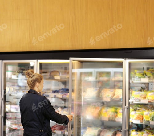 Preview: Woman Choosing Frozen Food From A Supermarket Freezer