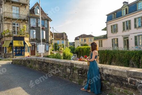 Preview: Tourist admiring picturesque canal in salies de bearn, france