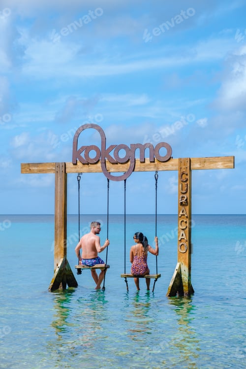Preview: Couple at a swing in the ocean of Curacao Caribbean Island, Kokomo Beach Curacao