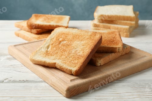 Preview: Board with toasts on white wooden background, close up