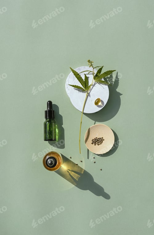 Preview: CBD oil in bottle and cannabis bush, hemp, white podium