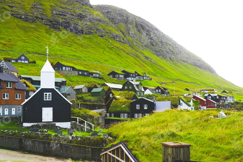 Preview: Small village with church surrounded by green mountains