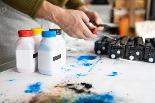 Preview: Printer technician engineer is refilling a laser toner cartridge. Office equipment maintenance conce