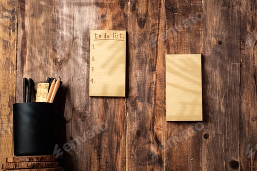 Preview: Office Supplies on Wooden Desk With List Notes