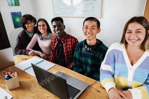 Preview: Portrait of happy multiracial students studying together at school - Focus on asian boy