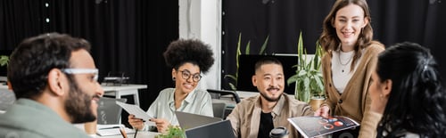 Preview: happy interracial business team looking at team leader on blurred foreground, brainstorming banner