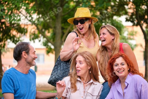 Preview: Five mature adults having fun in a park.