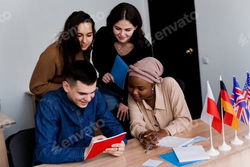 Preview: Teacher instructs multilingual students using laptops in language learning class