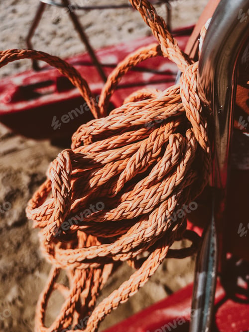 Preview: Vertical shot of a rope tied to e handrail