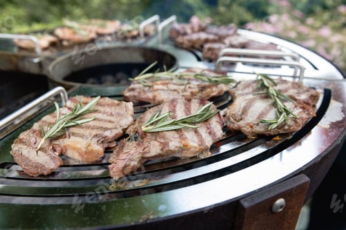 Preview: A beef steak from marbled beef seasoned with sprigs of rosemary