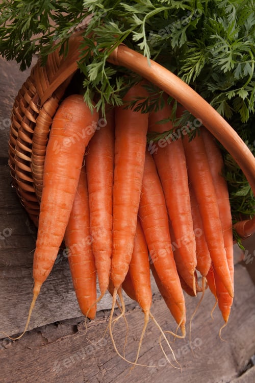 Preview: Fresh Carrots in Wicker Basket on Rustic Wood