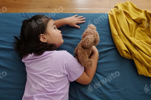 Preview: Girl Resting On Bed With Toy