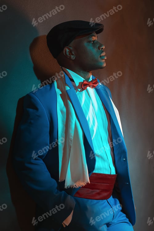 Preview: Retro African American Man In Blue Suit Wearing Blue Cap. Leaning Against Gray Wall.