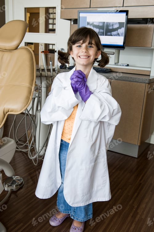 Preview: A portrait of a young Caucasian girl playing dress up in a dental office.