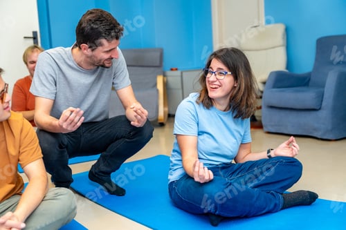 Preview: Yoga instructor teaching the lotus position to a disabled woman