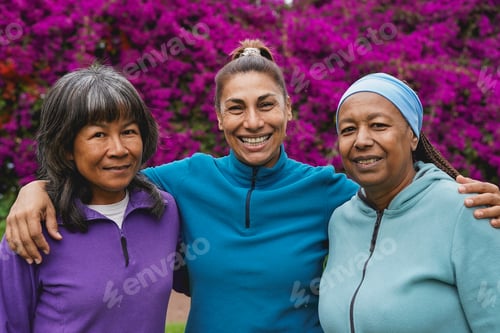 Preview: Happy multiracial mature women hugging each other otudoor after sport workout