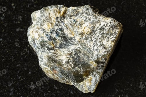 Preview: sample of rough dark labradorite rock on black