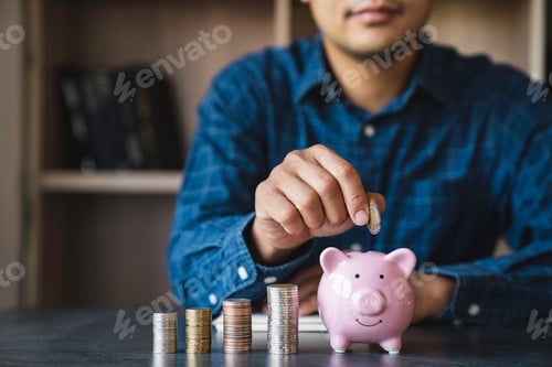 Preview: Businessman holding coins putting in a piggy bank. concept of saving money for finance accounting, f