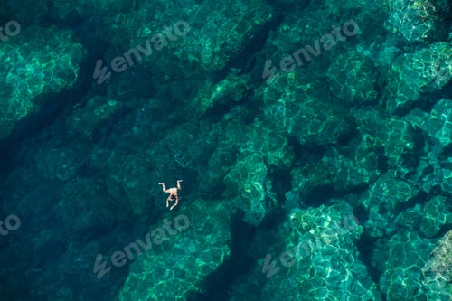 Preview: Drone view of a woman snorkeling in the sea. Summer vacation concept