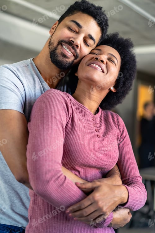 Preview: Portrait of happy smiling black couple in love having fun and hugging together