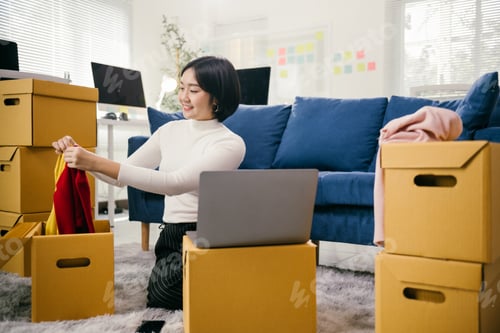 Preview: Online seller preparing clothes for shipping in her home office