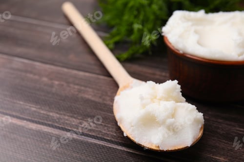 Preview: Spoon with delicious pork lard on wooden table, closeup. Space for text