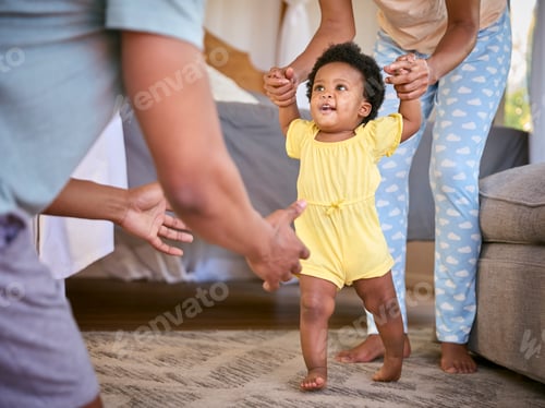 Preview: Family Shot As Parents Wearing Pyjamas Help Young Daughter To Walk Indoors At Home